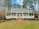 Beautiful home with a classic front porch, manicured lawn, and inviting curb appeal at 5413 Leopards Bane Ct, Holly Springs, NC 27540