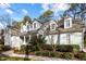 A charming house with dormer windows and well-maintained landscaping under a bright sky at 5413 Leopards Bane Ct, Holly Springs, NC 27540