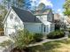 Back exterior featuring light blue siding, white garage door and trim, and a well-manicured yard at 5413 Leopards Bane Ct, Holly Springs, NC 27540