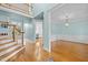 Elegant foyer with hardwood floors, a staircase, and views into the dining and kitchen areas at 5413 Leopards Bane Ct, Holly Springs, NC 27540