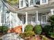 A welcoming porch with brick columns and steps, framed by manicured shrubs at 5413 Leopards Bane Ct, Holly Springs, NC 27540