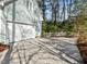 Side of home featuring an attached garage with a white door and mature trees in the background at 5413 Leopards Bane Ct, Holly Springs, NC 27540
