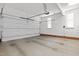 Spacious and well-lit two-car garage with a concrete floor and an automatic door opener at 5413 Leopards Bane Ct, Holly Springs, NC 27540