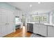 Bright kitchen with white cabinets, built-in desk, and stainless steel appliances at 5413 Leopards Bane Ct, Holly Springs, NC 27540