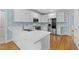 Well-lit kitchen with quartz countertops, stainless steel appliances, and ample cabinet space at 5413 Leopards Bane Ct, Holly Springs, NC 27540