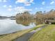 Scenic view of a lake from a walking path, showing tranquil waterfront scenery and green space at 5413 Leopards Bane Ct, Holly Springs, NC 27540