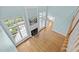 Open-concept living room has hardwood floors, fireplace, and large windows offering ample natural light at 5413 Leopards Bane Ct, Holly Springs, NC 27540