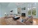 Inviting living room featuring tall windows, a fireplace, and comfortable seating at 5413 Leopards Bane Ct, Holly Springs, NC 27540