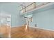 Spacious living room with hardwood floors, staircase, and an open floor plan at 5413 Leopards Bane Ct, Holly Springs, NC 27540