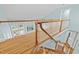 Bright staircase with white wood railings and wood floors lead to the upper level at 5413 Leopards Bane Ct, Holly Springs, NC 27540
