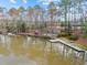Scenic waterfront featuring kayaks, a small dock, and lake access, ideal for recreational activities at 5413 Leopards Bane Ct, Holly Springs, NC 27540