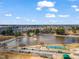 Scenic aerial view of a lake with fountain and sports fields in the distance, surrounded by trees at 561 Circle Dr, Angier, NC 27501