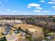 Aerial view of the neighborhood with a nearby park, playground, and plenty of green space at 561 Circle Dr, Angier, NC 27501