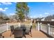 Back deck with table and chairs overlooks the lush backyard and fencing for privacy at 561 Circle Dr, Angier, NC 27501