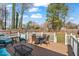 Outdoor living space features a deck with patio furniture and overlooks a large, fenced yard at 561 Circle Dr, Angier, NC 27501