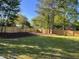 Spacious backyard featuring a well-maintained lawn and a newly installed wooden fence at 561 Circle Dr, Angier, NC 27501