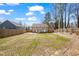 Wide shot of backyard with privacy fence, a small deck, and freshly mowed lawn at 561 Circle Dr, Angier, NC 27501