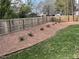 Large backyard with a privacy fence and mulch landscaping, perfect for outdoor activities at 561 Circle Dr, Angier, NC 27501