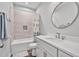 Well-lit bathroom with a shower-tub, sleek vanity, and decorative mirror, offering a blend of style and functionality at 561 Circle Dr, Angier, NC 27501