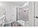 Modern bathroom featuring a glass-enclosed shower with grey tiling and a built-in bench at 561 Circle Dr, Angier, NC 27501
