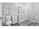 Well-lit bathroom with double vanity, modern fixtures, and ample storage space, offering a clean aesthetic at 561 Circle Dr, Angier, NC 27501