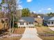 Inviting home featuring a covered porch, neat landscaping, and a wide driveway at 561 Circle Dr, Angier, NC 27501