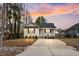 Charming single-story home featuring a cozy front porch and a large driveway, perfect for a starter home at 561 Circle Dr, Angier, NC 27501