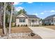 Charming home with a well-manicured front yard, inviting porch, and a flowing creek bed at 561 Circle Dr, Angier, NC 27501
