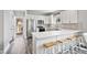 Bright kitchen with white cabinets, stainless steel appliances, and a breakfast bar with seating at 561 Circle Dr, Angier, NC 27501
