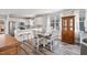 Open concept kitchen with white cabinets, stainless steel appliances, and a dining area at 561 Circle Dr, Angier, NC 27501