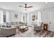 Cozy living room with comfortable seating, a ceiling fan, and large windows with natural light at 561 Circle Dr, Angier, NC 27501