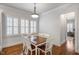 Dining area with hardwood floors and bright light from shuttered windows at 5712 Kirkwood Park Dr, Raleigh, NC 27612