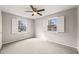 Bright bedroom with a ceiling fan and two windows with wooden blinds at 5815 Windham Dr, Raleigh, NC 27609