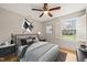 Comfortable bedroom with a window view, neutral colors, and hardwood floors at 5815 Windham Dr, Raleigh, NC 27609