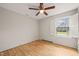 Bedroom with hardwood floors, a ceiling fan, and bright window at 5815 Windham Dr, Raleigh, NC 27609