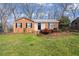 Charming brick home with well-maintained landscaping and front lawn at 5815 Windham Dr, Raleigh, NC 27609