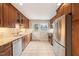 Well-lit kitchen featuring stainless steel appliances, wood cabinets, and a tile floor at 5815 Windham Dr, Raleigh, NC 27609