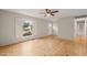 Bright living room with natural wood floors and a large window with white shutters at 5815 Windham Dr, Raleigh, NC 27609