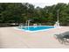Outdoor swimming pool with diving board and lifeguard stand, surrounded by trees at 5815 Windham Dr, Raleigh, NC 27609