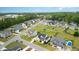 Aerial view of a home in a suburban neighborhood with mature trees and well-maintained lawns at 5820 Brayton Park Pl, Holly Springs, NC 27540