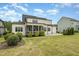 Home's backyard with patio, lawn, and screened porch, perfect for outdoor enjoyment at 5820 Brayton Park Pl, Holly Springs, NC 27540