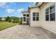 Backyard patio featuring stone pavers and view of the screened in porch of the home at 5820 Brayton Park Pl, Holly Springs, NC 27540