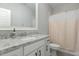 Bathroom featuring granite countertops, white cabinets, brushed nickel finishes, and a shower-tub combo at 5820 Brayton Park Pl, Holly Springs, NC 27540