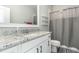 Updated bathroom featuring granite countertops, white vanity, and shower with tub at 5820 Brayton Park Pl, Holly Springs, NC 27540