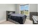 Neutral bedroom featuring a ceiling fan, bright window, gray walls, soft carpet, and a queen bed at 5820 Brayton Park Pl, Holly Springs, NC 27540