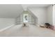 Bright bonus room featuring neutral walls and carpet, and unique built-in shelving at 5820 Brayton Park Pl, Holly Springs, NC 27540