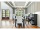 Elegant dining room with hardwood floors, a chandelier, and views of the backyard at 5820 Brayton Park Pl, Holly Springs, NC 27540
