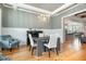 Open dining area with hardwood floors, chandelier, and views of the kitchen and living room at 5820 Brayton Park Pl, Holly Springs, NC 27540