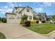 Two-story home with a well-manicured lawn, and a two car attached garage at 5820 Brayton Park Pl, Holly Springs, NC 27540