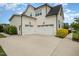 Spacious two-car garage with white doors and ample parking space at 5820 Brayton Park Pl, Holly Springs, NC 27540